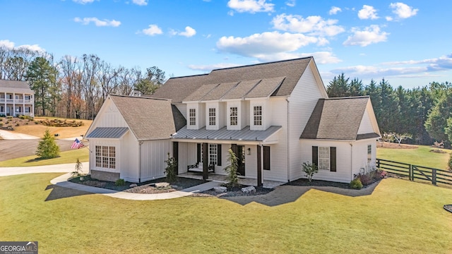 200 Ivy Meadow Way, Ball Ground, GA 30107 - back of property with board and batten siding, covered porch, roof with shingles, a metal roof, and a standing seam roof