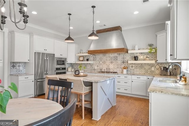 200 Ivy Meadow Way, Ball Ground, GA 30107 - kitchen with open shelves, stainless steel appliances, wall chimney range hood, white cabinetry, and crown molding