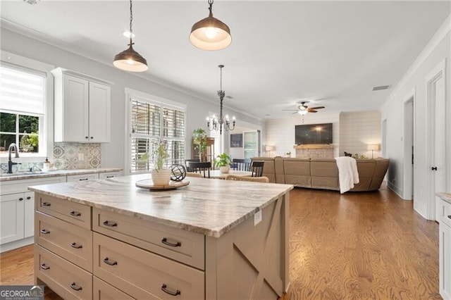 200 Ivy Meadow Way, Ball Ground, GA 30107 - kitchen with a ceiling fan, tasteful backsplash, a kitchen island, pendant lighting, and crown molding