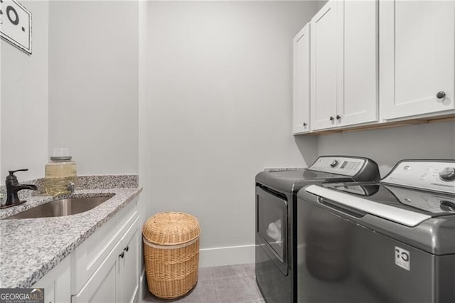 200 Ivy Meadow Way, Ball Ground, GA 30107 - laundry room featuring washing machine and dryer, cabinet space, and light tile patterned floors