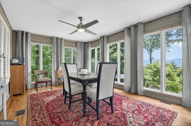 312 Mollie Mountain Trl, Ellijay, GA 30536 - dining space with ceiling fan, light wood finished floors, and wood walls