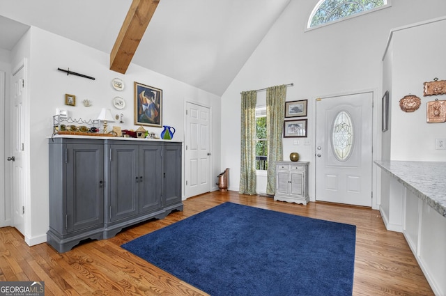312 Mollie Mountain Trl, Ellijay, GA 30536 - kitchen with stainless steel appliances, high vaulted ceiling, a peninsula, white cabinetry, and a breakfast bar area