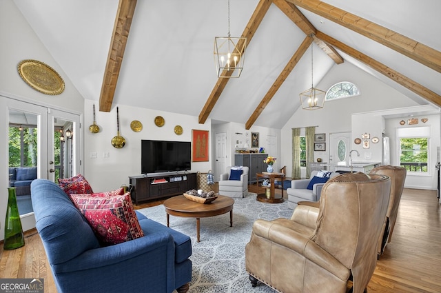 312 Mollie Mountain Trl, Ellijay, GA 30536 - living room featuring high vaulted ceiling, wood finished floors, beam ceiling, a chandelier, and plenty of natural light