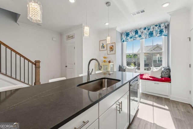 1621 Wellborn Walk, Suwanee, GA 30024 - kitchen with dishwasher, dark countertops, white cabinetry, decorative light fixtures, and light wood-style floors