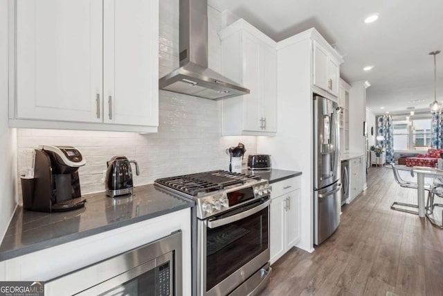 1621 Wellborn Walk, Suwanee, GA 30024 - kitchen featuring wall chimney range hood, stainless steel appliances, white cabinets, recessed lighting, and backsplash