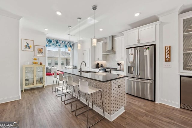 1621 Wellborn Walk, Suwanee, GA 30024 - kitchen with stainless steel appliances, wall chimney range hood, an island with sink, decorative backsplash, and dark countertops