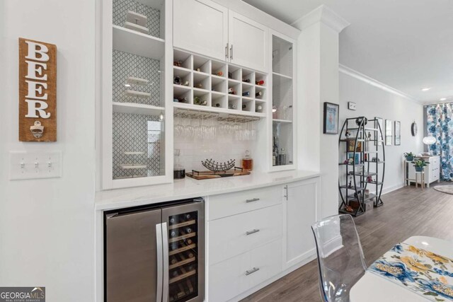 1621 Wellborn Walk, Suwanee, GA 30024 - indoor dry bar featuring beverage cooler, dark wood-style floors, and ornamental molding