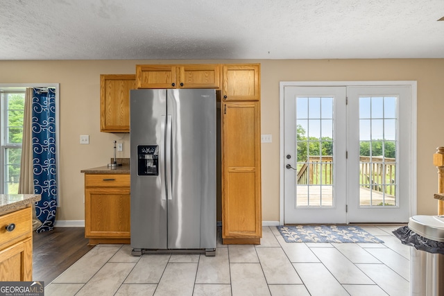 107 Line Creek Rd, Nicholson, GA 30565 - kitchen featuring stainless steel fridge, plenty of natural light, a textured ceiling, and light tile patterned floors