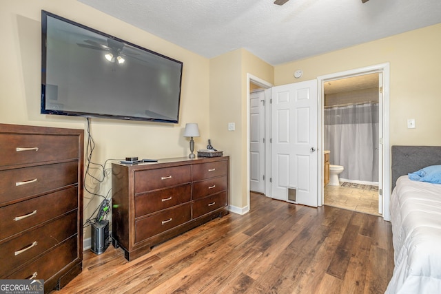 107 Line Creek Rd, Nicholson, GA 30565 - bedroom with dark wood-style floors, connected bathroom, and a textured ceiling