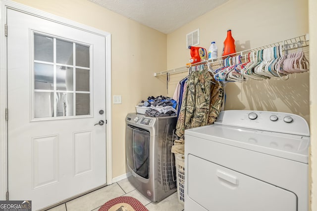 107 Line Creek Rd, Nicholson, GA 30565 - laundry room with washing machine and clothes dryer, light tile patterned flooring, and a textured ceiling