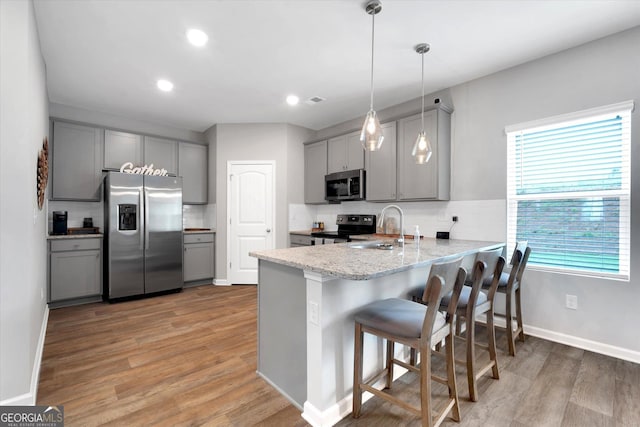 217 Rusty Plow Ln Unit 68, Perry, GA 31069 - kitchen with appliances with stainless steel finishes, gray cabinetry, a peninsula, backsplash, and light wood finished floors