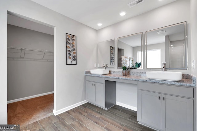 217 Rusty Plow Ln Unit 68, Perry, GA 31069 - full bathroom featuring double vanity, wood finish floors, a walk in closet, and recessed lighting