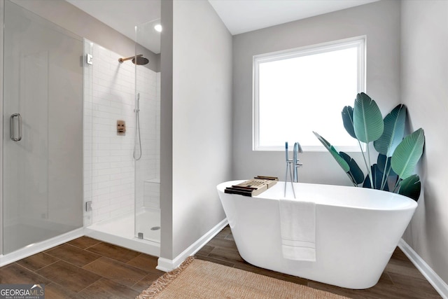 217 Rusty Plow Ln Unit 68, Perry, GA 31069 - bathroom with a stall shower, a soaking tub, and wood tiled floors