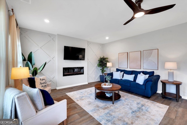 217 Rusty Plow Ln Unit 68, Perry, GA 31069 - living room featuring dark wood-style floors, a ceiling fan, a glass covered fireplace, recessed lighting, and a decorative wall