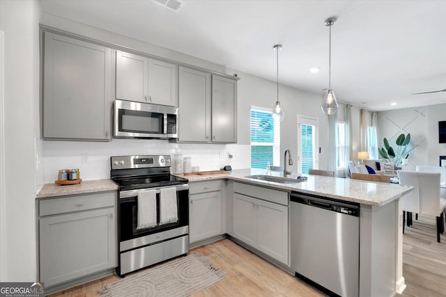 217 Rusty Plow Ln Unit 68, Perry, GA 31069 - kitchen featuring appliances with stainless steel finishes, gray cabinets, a peninsula, tasteful backsplash, and open floor plan