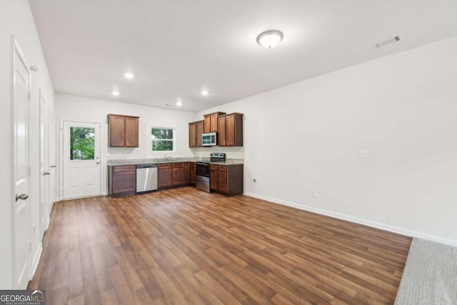 4001 Avalon Rd SW, Atlanta, GA 30331 - kitchen featuring stainless steel appliances, dark wood-style flooring, recessed lighting, and brown cabinetry