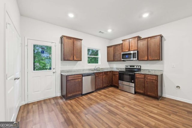 4001 Avalon Rd SW, Atlanta, GA 30331 - kitchen featuring stainless steel appliances, light wood-type flooring, light stone countertops, and recessed lighting