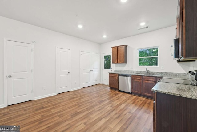 4001 Avalon Rd SW, Atlanta, GA 30331 - kitchen featuring appliances with stainless steel finishes, light wood-style floors, recessed lighting, and light stone counters
