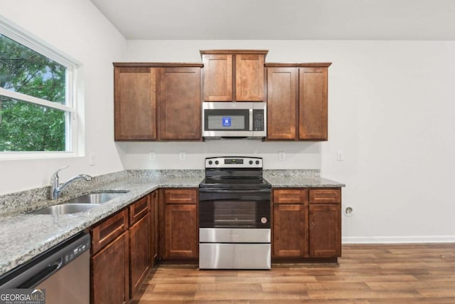 4001 Avalon Rd SW, Atlanta, GA 30331 - kitchen with appliances with stainless steel finishes, light stone countertops, and wood finished floors