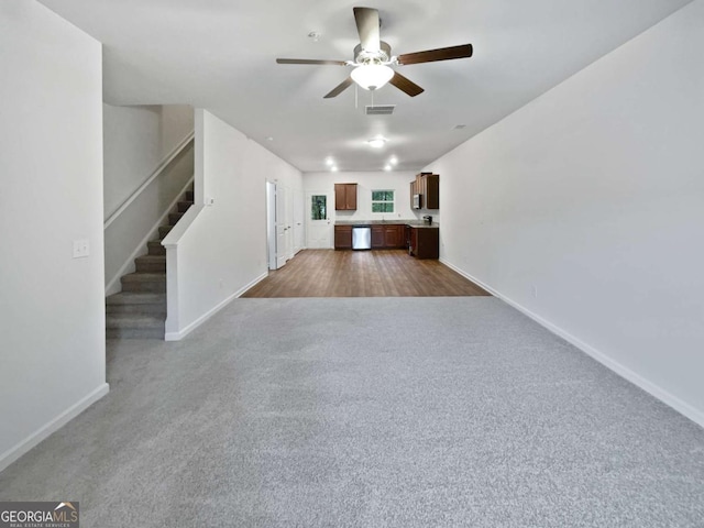 4001 Avalon Rd SW, Atlanta, GA 30331 - unfurnished living room with a ceiling fan, stairway, and dark colored carpet