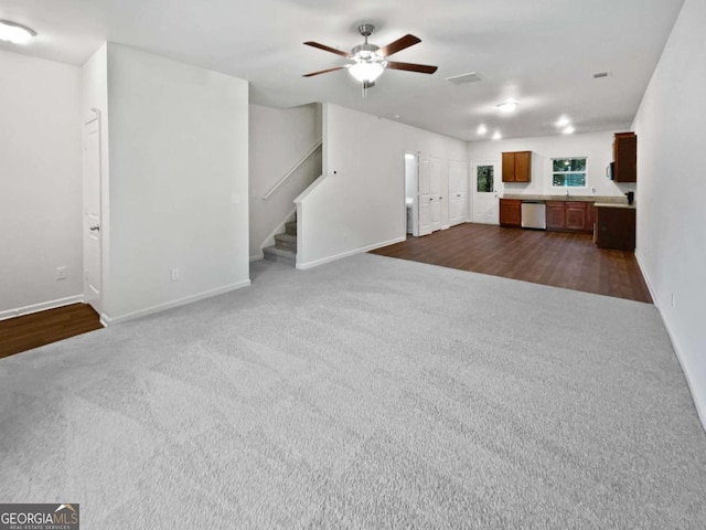 4001 Avalon Rd SW, Atlanta, GA 30331 - unfurnished living room with dark colored carpet, a ceiling fan, and stairs
