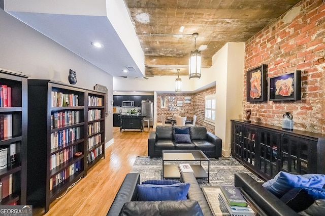1026 Saint Charles Ave NE Unit 15, Atlanta, GA 30306 - living room with light wood-style flooring and brick wall