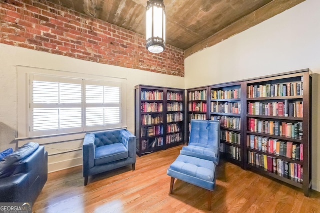 1026 Saint Charles Ave NE Unit 15, Atlanta, GA 30306 - sitting room with wood finished floors, bookshelves, wooden ceiling, and a high ceiling