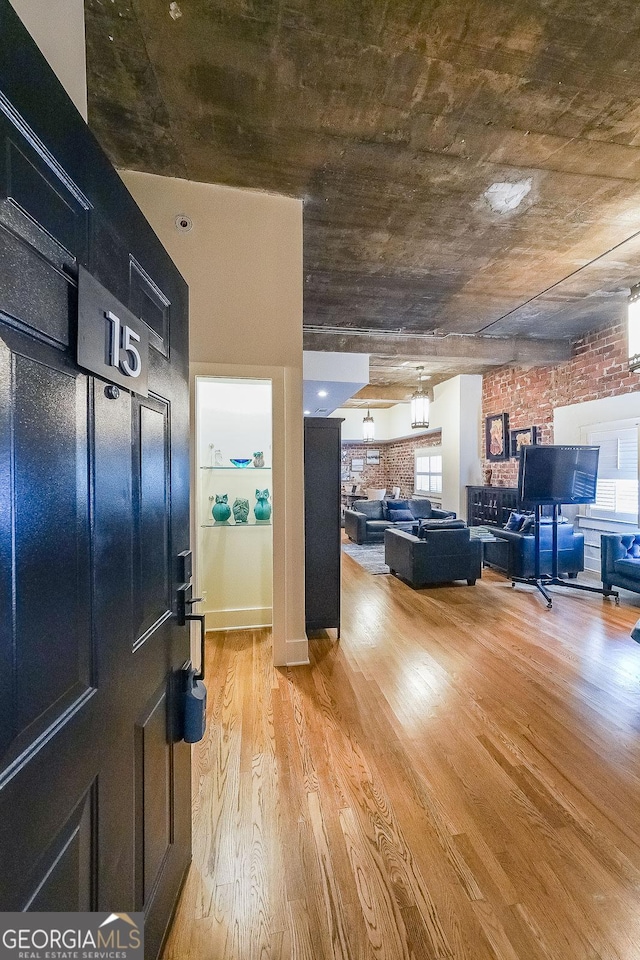 1026 Saint Charles Ave NE Unit 15, Atlanta, GA 30306 - foyer featuring light wood-style flooring, brick wall, and plenty of natural light