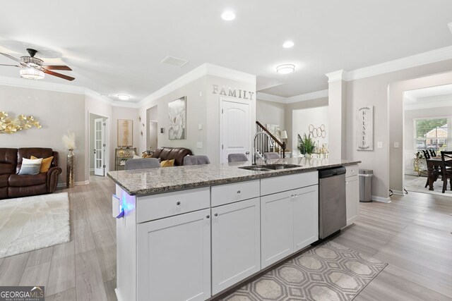 140 Canyons Ct, Hampton, GA 30228 - kitchen featuring stainless steel dishwasher, open floor plan, light stone countertops, a ceiling fan, and light wood-style flooring
