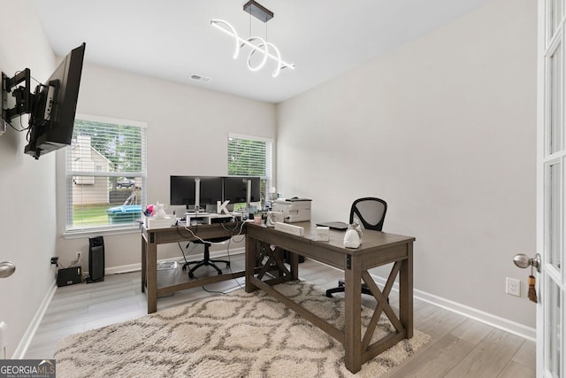140 Canyons Ct, Hampton, GA 30228 - home office with plenty of natural light, wood finished floors, and a chandelier