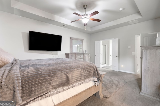 140 Canyons Ct, Hampton, GA 30228 - carpeted bedroom with a raised ceiling and a ceiling fan