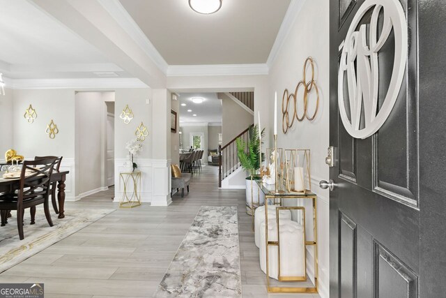 140 Canyons Ct, Hampton, GA 30228 - foyer entrance featuring ornamental molding, stairway, light wood-style floors, and a wainscoted wall