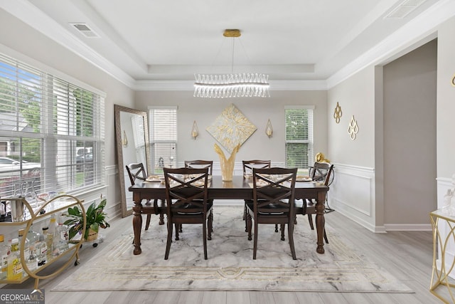 140 Canyons Ct, Hampton, GA 30228 - dining area with a chandelier, a tray ceiling, wood finished floors, and wainscoting
