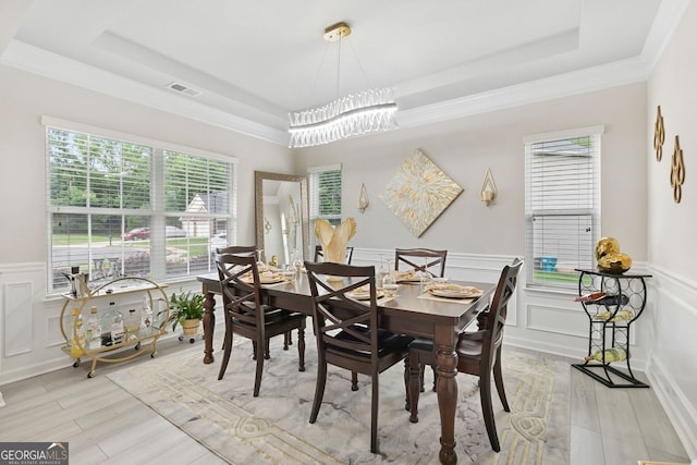 140 Canyons Ct, Hampton, GA 30228 - dining space featuring a tray ceiling, plenty of natural light, light wood-style flooring, a decorative wall, and wainscoting