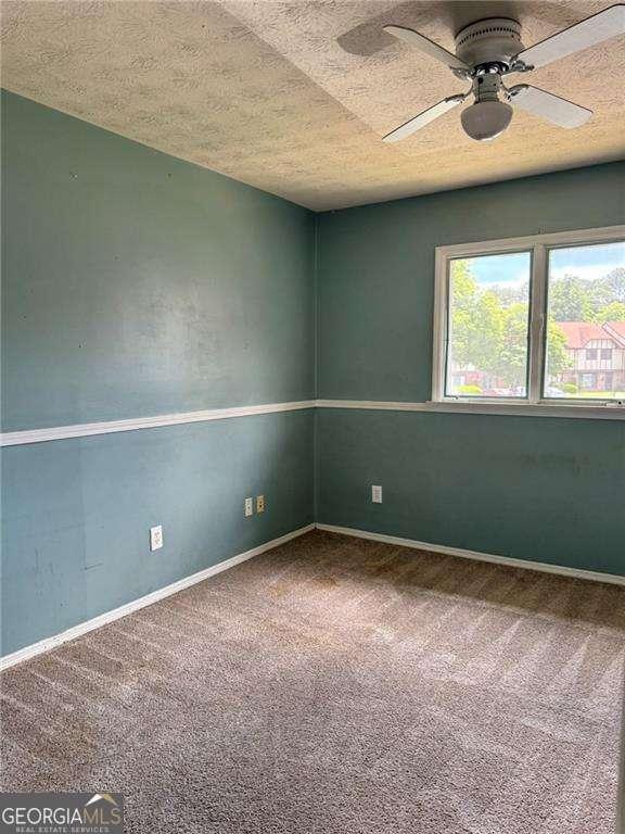 1807 Ashborough Cir SE Unit B, Marietta, GA 30067 - unfurnished room featuring carpet flooring, a textured ceiling, and ceiling fan