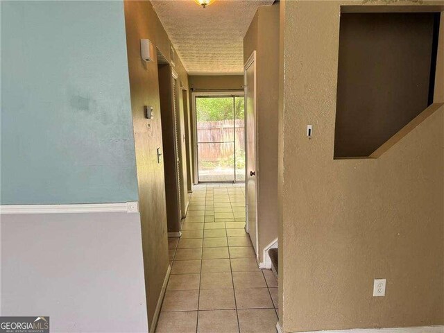 1807 Ashborough Cir SE Unit B, Marietta, GA 30067 - corridor with a textured wall, light tile patterned floors, and a textured ceiling
