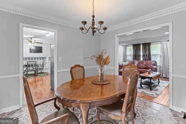 564 Allana Ct, Stone Mountain, GA 30087 - dining space featuring ornamental molding, a chandelier, a ceiling fan, and light wood-style flooring
