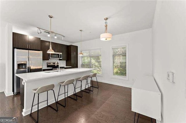19 Moda Ln, Atlanta, GA 30316 - kitchen with stainless steel appliances, a kitchen bar, decorative backsplash, light countertops, and a kitchen island with sink