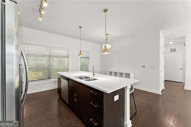 19 Moda Ln, Atlanta, GA 30316 - kitchen featuring appliances with stainless steel finishes, dark wood finished floors, a kitchen island with sink, dark brown cabinets, and light countertops