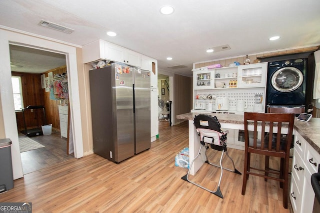 6110 Ga Highway 34, Franklin, GA 30217 - kitchen featuring freestanding refrigerator, white cabinets, light wood-style floors, stacked washing machine and dryer, and open shelves