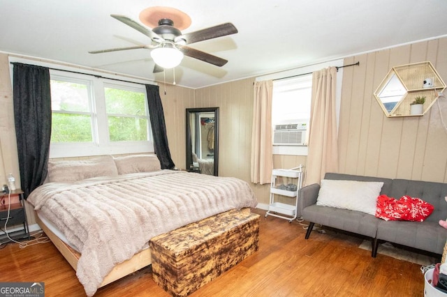 6110 Ga Highway 34, Franklin, GA 30217 - bedroom featuring wood finished floors, cooling unit, a ceiling fan, and wood walls