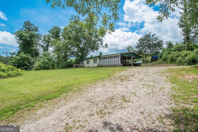6110 Ga Highway 34, Franklin, GA 30217 - view of grassy yard with driveway and a carport