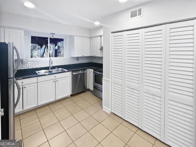 6220 Brookwood Rd, Peachtree Corners, GA 30092 - kitchen with stainless steel appliances, dark countertops, white cabinets, backsplash, and light tile patterned floors