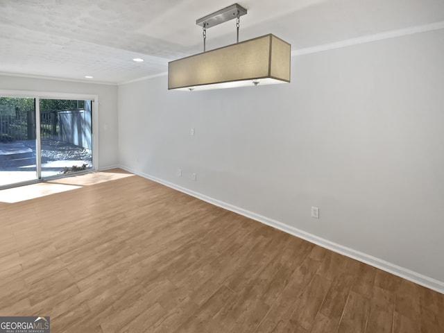 6220 Brookwood Rd, Peachtree Corners, GA 30092 - spare room with crown molding, wood finished floors, and recessed lighting