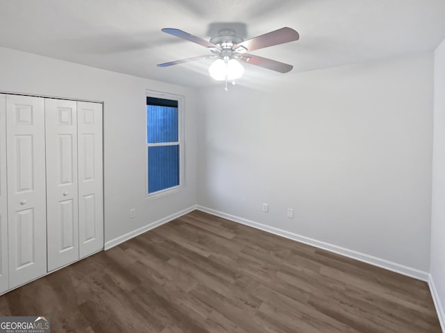6220 Brookwood Rd, Peachtree Corners, GA 30092 - unfurnished bedroom with dark wood-style flooring, a closet, and a ceiling fan