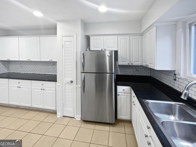 6220 Brookwood Rd, Peachtree Corners, GA 30092 - kitchen with freestanding refrigerator, dark countertops, white cabinets, and light tile patterned flooring