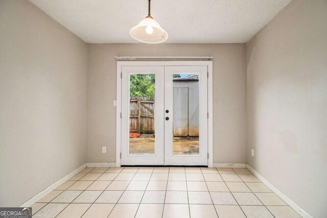 2039 Oak Park Ln, Decatur, GA 30032 - spare room featuring french doors, light tile patterned flooring, and a textured ceiling