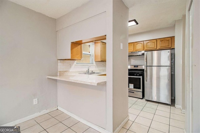 2039 Oak Park Ln, Decatur, GA 30032 - kitchen with stainless steel appliances, under cabinet range hood, tasteful backsplash, and light tile patterned flooring