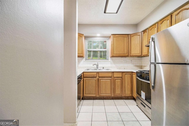 2039 Oak Park Ln, Decatur, GA 30032 - kitchen with stainless steel appliances, decorative backsplash, light countertops, a textured wall, and light tile patterned flooring