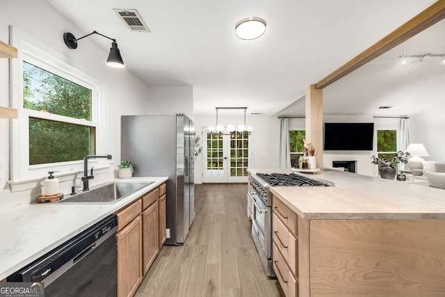 5315 Bentley Hall Dr, Alpharetta, GA 30005 - kitchen featuring appliances with stainless steel finishes, open floor plan, light countertops, light wood-style flooring, and french doors